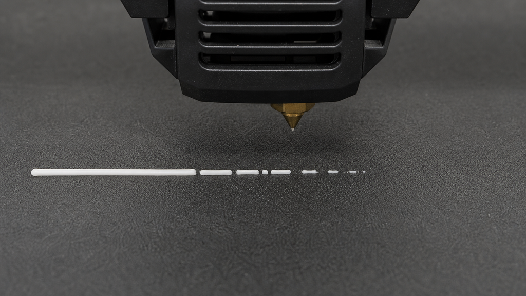 White extrusion line that changes from full flow to intermittent gaps and then stops beneath a printer nozzle.